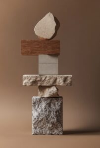 A conceptual stack of stone building bricks, concrete and timber. It is set agai...
