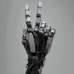 a bio mechanical hand with the ring finger pointing up, the other fingers are cl...