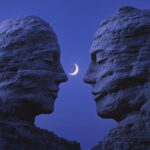 Two large rocks in the shape of human heads, they look at each other and smile, ...