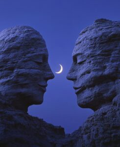 Two large rocks in the shape of human heads, they look at each other and smile, ...