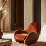 A sculptural Soft-Form Accent Chair in Smoky Rosewood with Warm Terracotta pipin...
