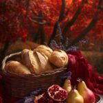 A lavish macro picnic scene with a wicker basket filled with freshly baked bague...