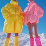 Two beautiful fashion models full body wide shot, wearing glasses, dressed in ov...