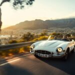 A white convertible E-type, front view, driving on the road, Cape Town, cinemati...