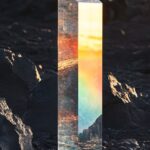 thin sheet of glass monument standing upright in a black stone query. evening li...