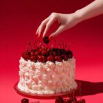 Prompt:A hand reaching for the cake a...