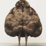 An oversized down jacket with an extremely large and voluminous back, which is r...