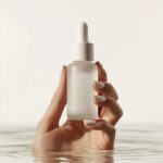 Create a marketing image featuring a skincare product held by a well-groomed han...