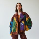An avant-garde suit with oversized shoulders, sculptural elements and organic pa...