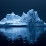 An abstract closeup photo of a beautiful sculpted iceberg floating in the ocean ...
