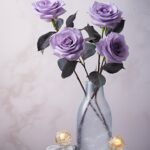 Commercial product photography. Damask roses, heliotrope flowers, leather, a bra...