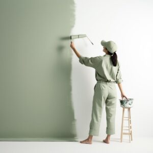 A normal really natural looking slightly overweight woman in a green painter sui...
