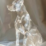 A diamond carved Doberman shining brilliantly in ambient sunlight, the mood is o...