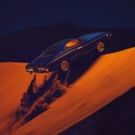 Dark blue car falling down from height and suspended in the air at the second be...