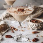 Create a image of a Butter Pecan Martini in a clear martini glass. The drink sho...