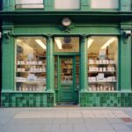 Storefront of a shop selling soap bars in 80s london city, nice building with gr...
