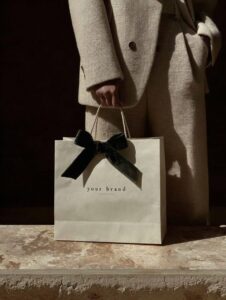 Prompta photo of an elegant woman holding and showcasing the "your brand" brand ...