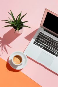 sleek flatlay with a laptop, a small plant and a coffee cup. Minimalist and phot...