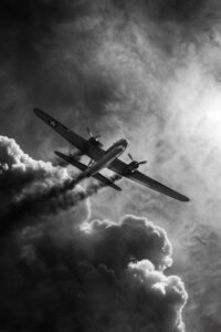 b17 bomber in steep dive and banking turn, clouds, smoking from an engine fire, ...