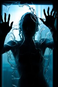 A woman's silhouette is shown through pitted glass with hands out with fist up, ...