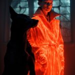 Double exposure shot of a woman in an orange coat standing next to a black dog, ...