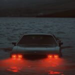 Epic surreal scene, art shows a car partly submerged in water with its interior ...