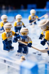 Wide shot photography of Lego Figurines playing Ice hockey, photo realistic, hig...