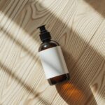 A hair care product like shampoo or conditioner bottle positioned on its side on...