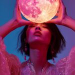 a woman in avant Garde apparel, Bring a pink glossy Moon with two hands, translu...