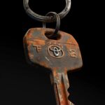 RUSTY Toyota car keys with Ein key chain, floating in black background , full de...