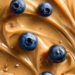 Prompt:close-up texture of [COLOR] [CREAM TYPE] with [NUMBER] [TOPPING], soft sw...