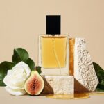 an editorial still life image of a bottle of perfume sitting on a stone table wi...