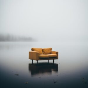 Photo of a brocken big sofa sticking out of the lake, fog mads berg, design chai...