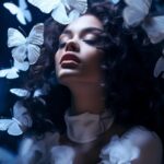 A beatiful young woman with white makeup and white butterflies on her face, danc...